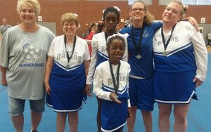 Picture of Coach Ruth with the cheer team.