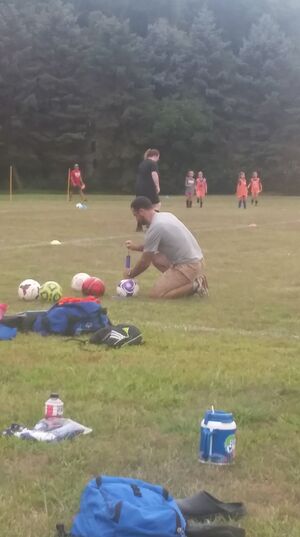 Picture of Coach Tyler at soccer practice.