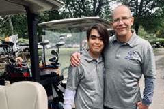 Golfers with a golf cart.