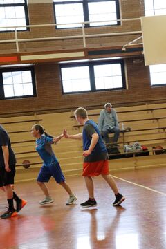 Basketball players giving a high five.